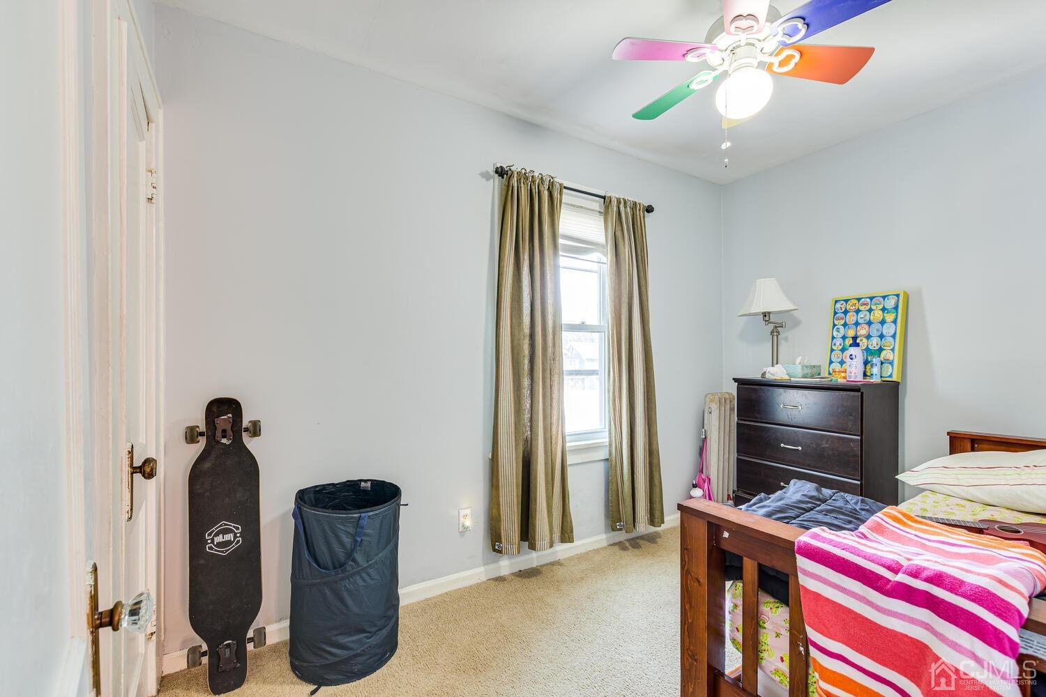 44 Freeman Street Woodbridge, NJ 07095 - Photo 7 of 8 a bedroom with a bed and a chandelier