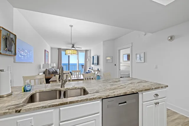 a kitchen with stainless steel appliances granite countertop a stove top oven a refrigerator a sink and dishwasher