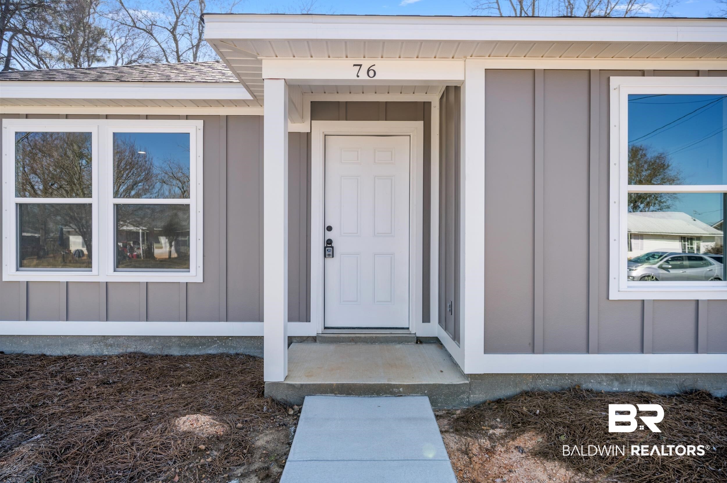 76 Fincher Lane Loxley, AL 36551 - Photo 4 of 33 Property entrance featuring board and batten siding and a shingled roof