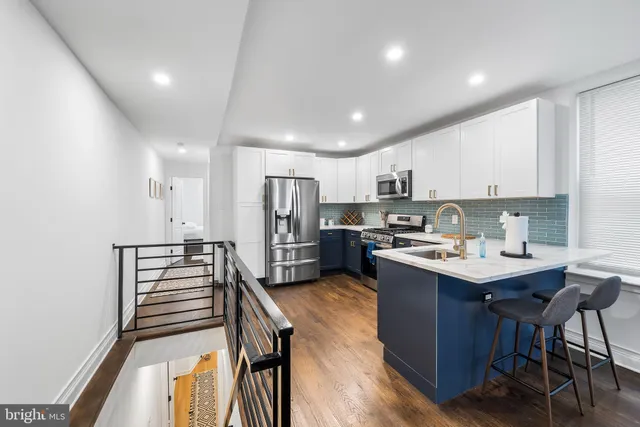 a kitchen with refrigerator and cabinets