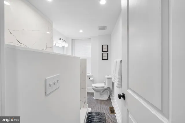 a bathroom with a toilet and a shower