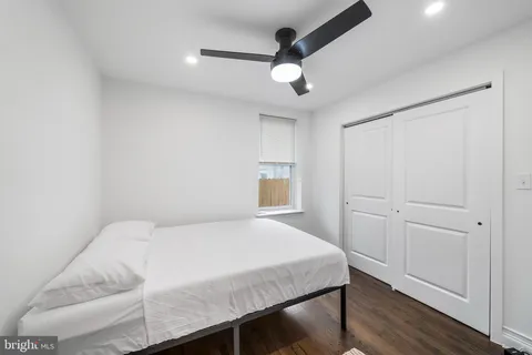 a bedroom with a bed and a ceiling fan