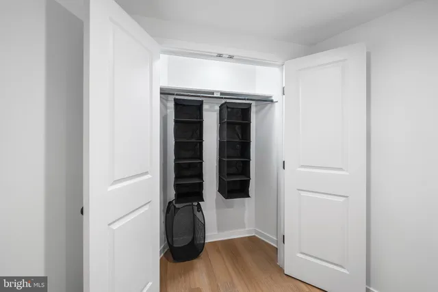 a view of walk in closet with empty racks