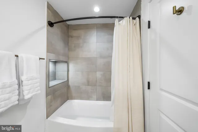 a bathroom with a shower and a tub