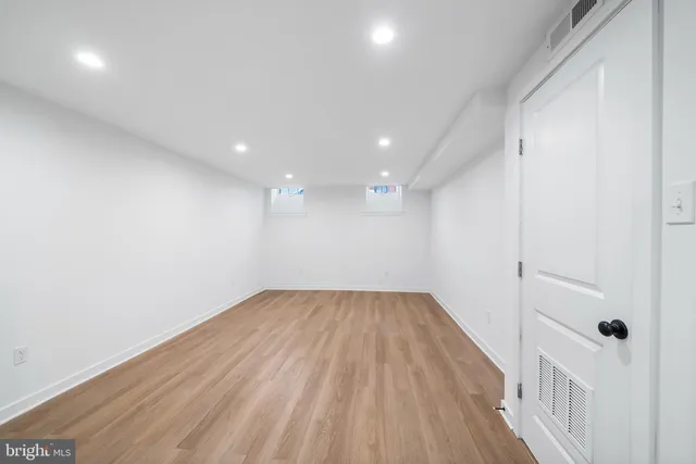 a view of a hallway with wooden floor