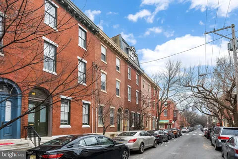 a couple of cars parked in front of a building