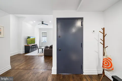a view of living room filled with furniture and wooden floor