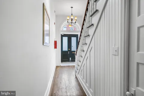 a view of an entryway with wooden floor