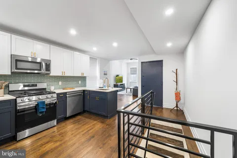 a kitchen with stainless steel appliances granite countertop a stove sink microwave and cabinets