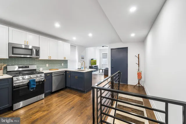 a kitchen with stainless steel appliances granite countertop a stove sink microwave and cabinets