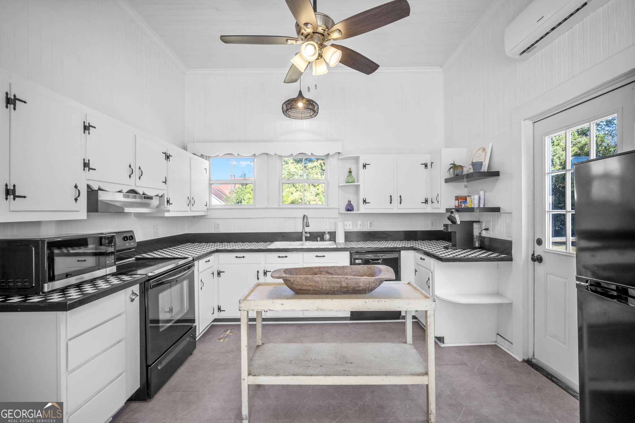 295 South Lewis Street Metter, GA 30439 - Photo 15 of 24 a kitchen with a stove a sink and a refrigerator