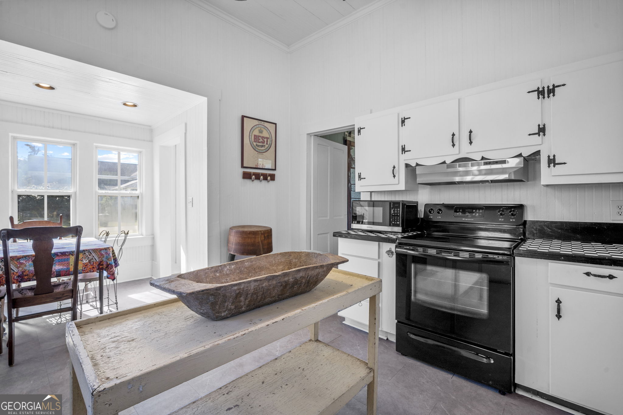 295 South Lewis Street Metter, GA 30439 - Photo 16 of 24 a kitchen with stainless steel appliances granite countertop a stove and white cabinets