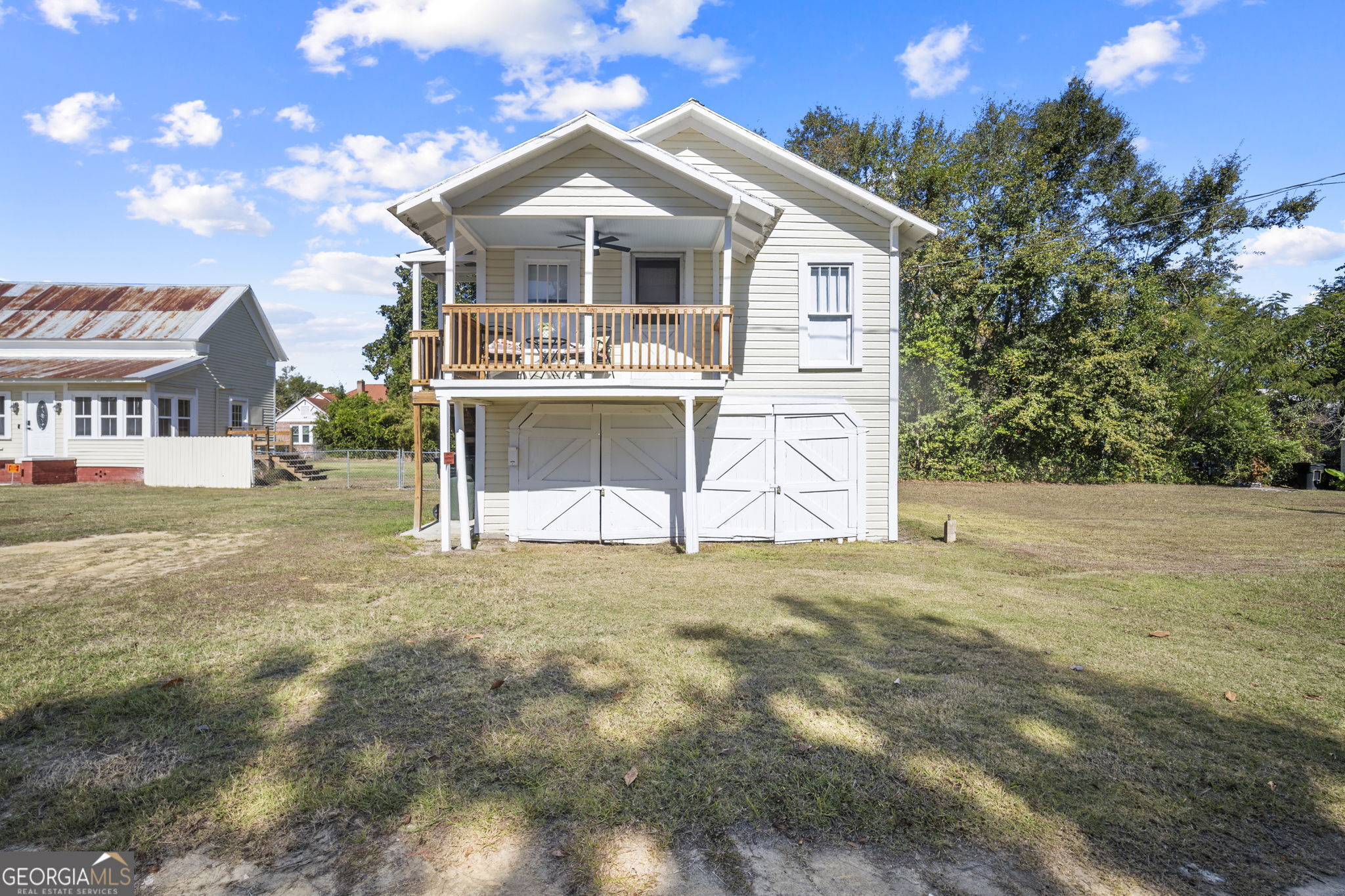 295 South Lewis Street Metter, GA 30439 - Photo 23 of 24 a view of a house with a yard and potted plants