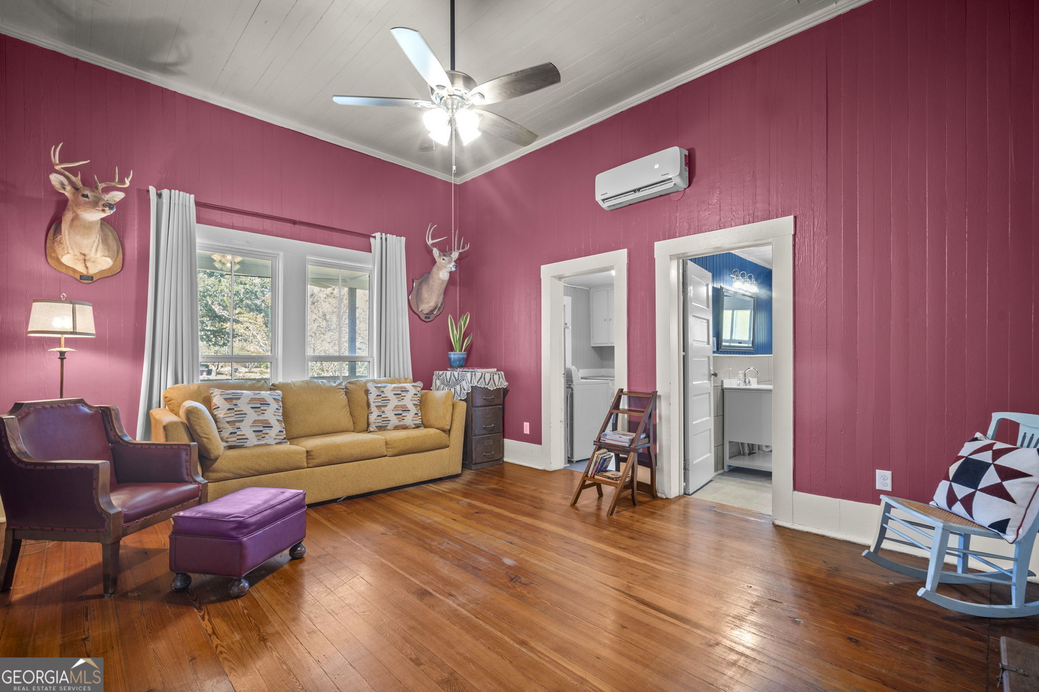 295 South Lewis Street Metter, GA 30439 - Photo 3 of 24 a living room with furniture gym equipment and a large window