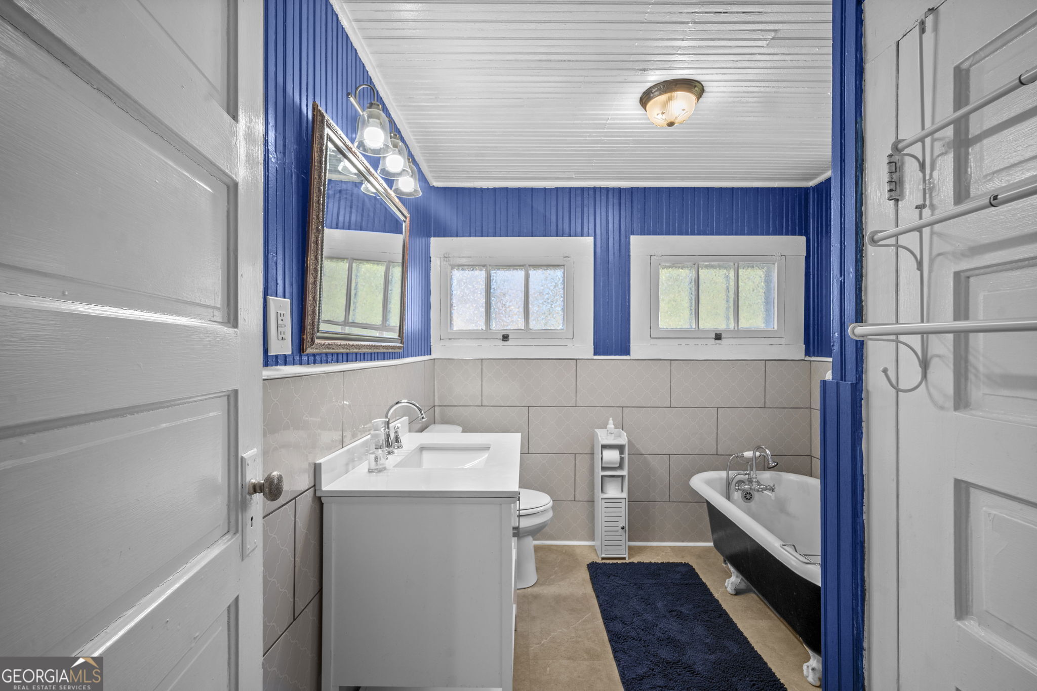 295 South Lewis Street Metter, GA 30439 - Photo 6 of 24 a bathroom with a sink a vanity and a mirror