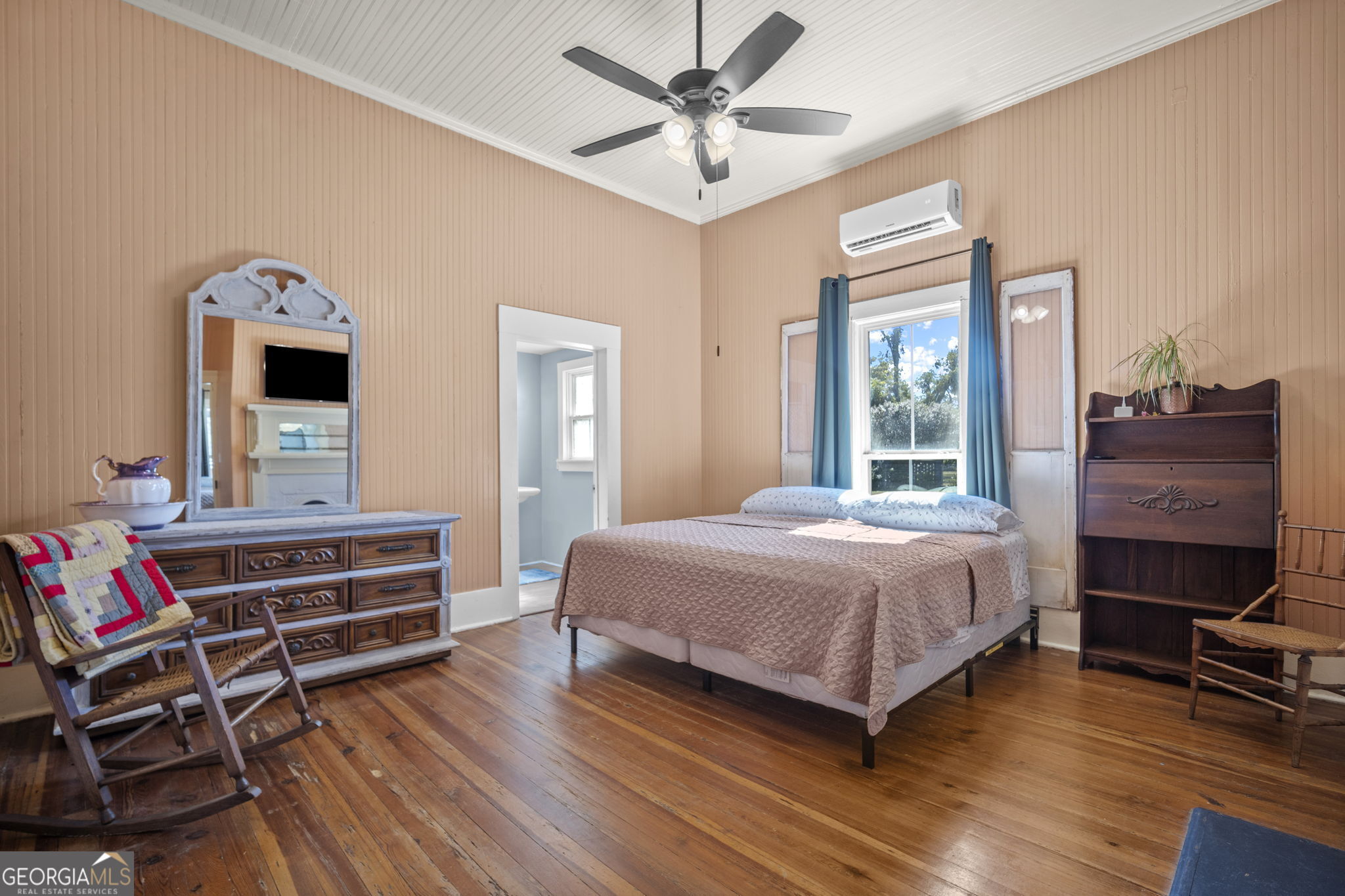 295 South Lewis Street Metter, GA 30439 - Photo 8 of 24 a bedroom with a bed and wooden floor