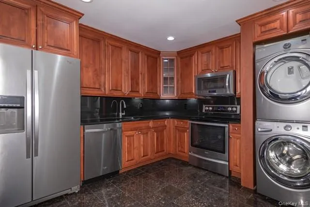 a kitchen with stainless steel appliances granite countertop a refrigerator sink and stove top oven