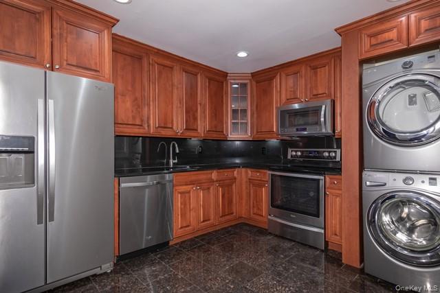 1314 Smithtown Avenue, Unit 29 Bohemia, NY 11716 - Photo 2 of 8 a kitchen with stainless steel appliances granite countertop a refrigerator sink and stove top oven