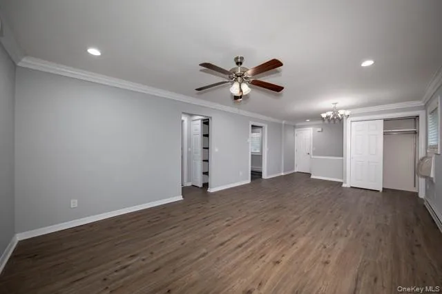 a view of a big room with wooden floor and a ceiling fan
