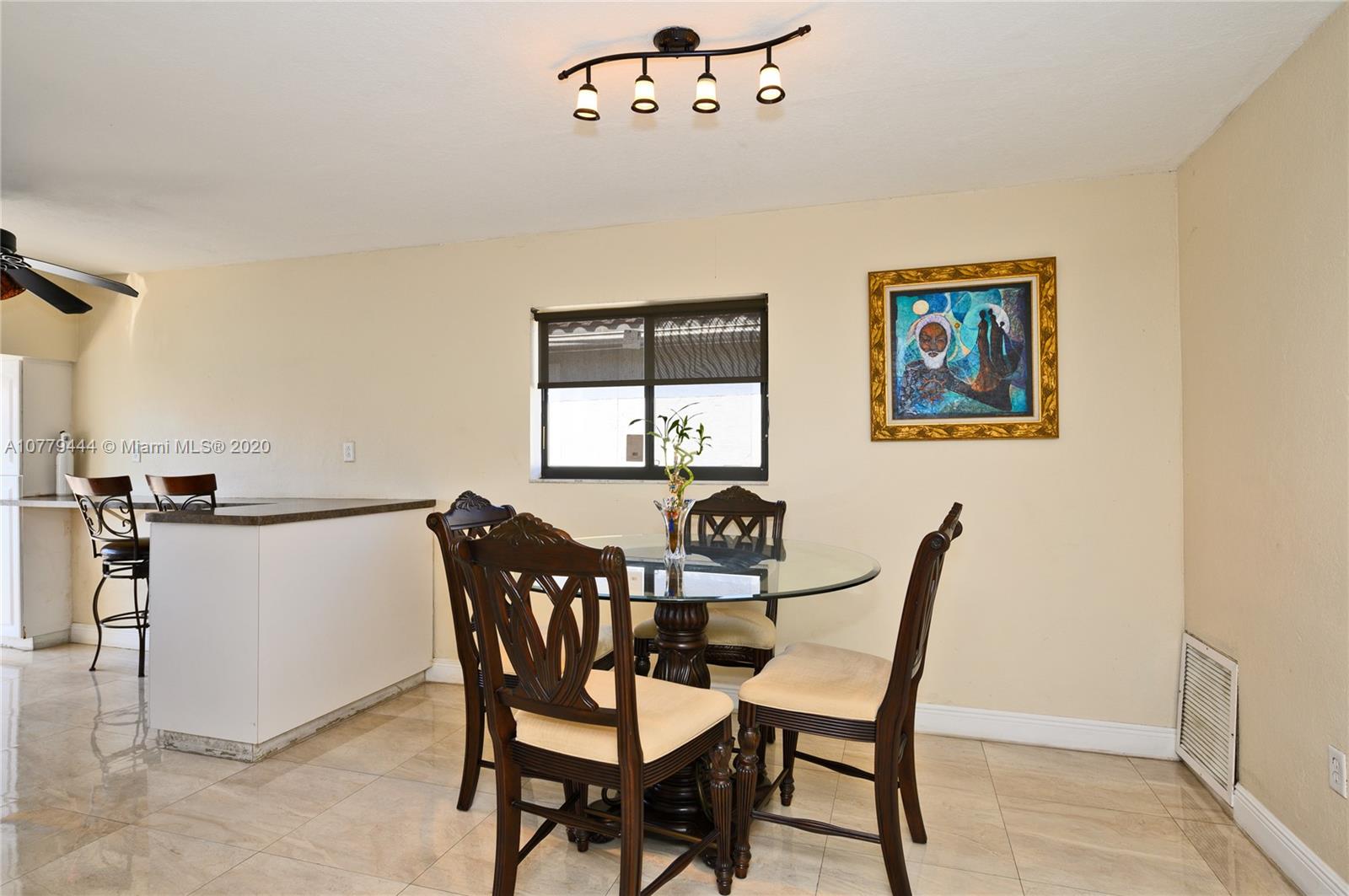 3816 East Lake Road Miramar, FL 33023 - Photo 7 of 25 a view of a dining room with furniture and window