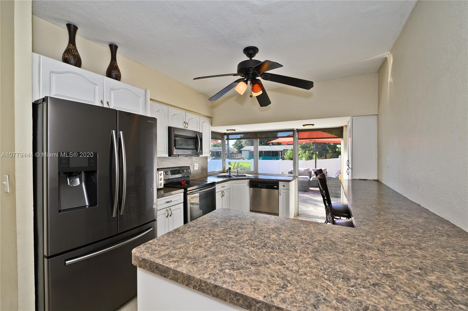 3816 East Lake Road Miramar, FL 33023 - Photo 9 of 25 a kitchen with stainless steel appliances granite countertop a refrigerator a stove and a sink