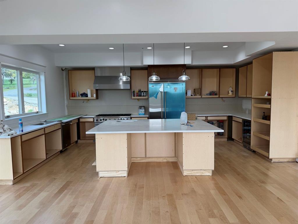 499 Freeport Road Freeport, PA 16229 - Photo 4 of 21 a large kitchen with stainless steel appliances a large counter top a stove a sink and a refrigerator