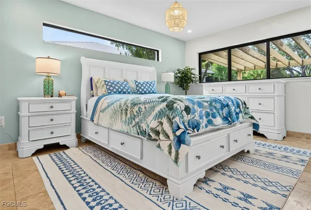 a bed sitting in a bedroom next to a window