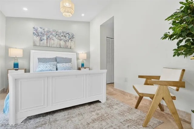 a bedroom with a bed and a chair