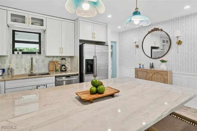 a kitchen with kitchen island a stove a sink and a refrigerator