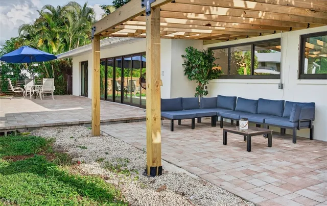 a backyard of a house with table and chairs