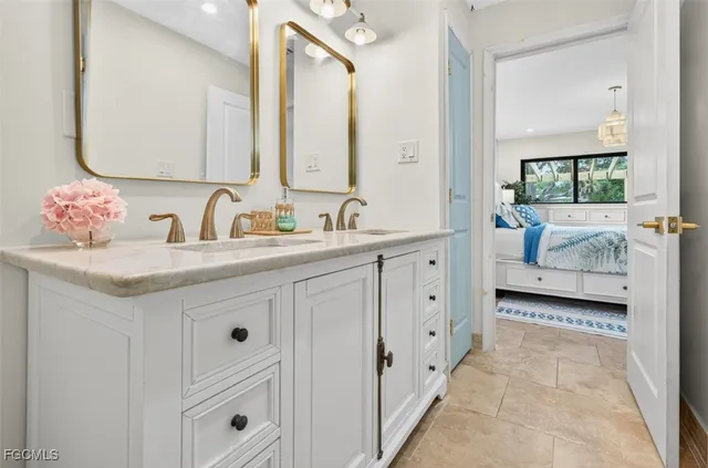 a bathroom with a double vanity sink and a mirror