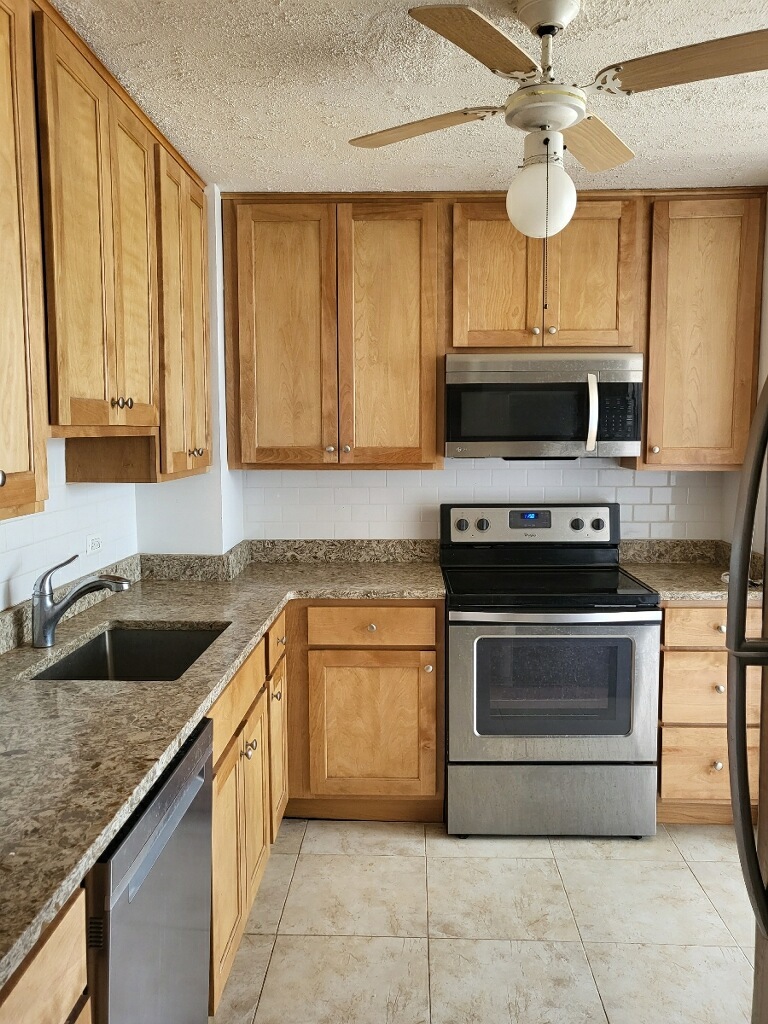 5701 North Sheridan Road, Unit 30B Chicago, IL 60660 - Photo 2 of 9 a kitchen with a stove microwave and cabinets