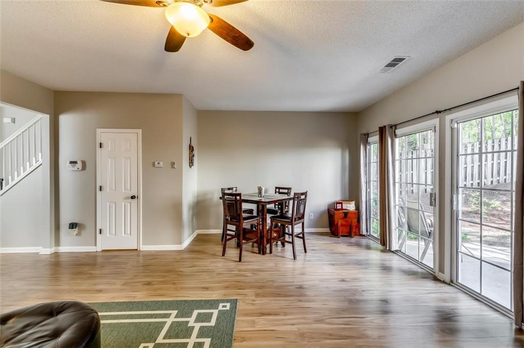 4175 Howell Park Road Duluth, GA 30096 - Photo 11 of 36 a view of a dining room with furniture and wooden floor
