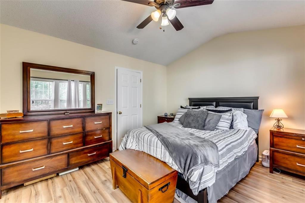 4175 Howell Park Road Duluth, GA 30096 - Photo 16 of 36 a bedroom with a bed and wooden floor