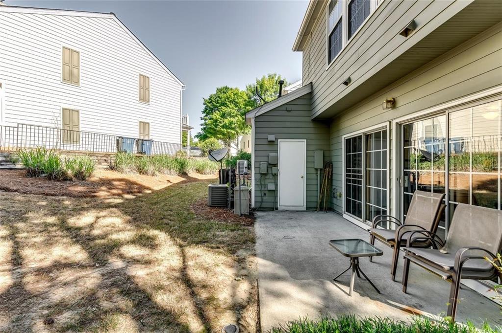 4175 Howell Park Road Duluth, GA 30096 - Photo 26 of 36 a view of a patio with table and chairs and wooden fence