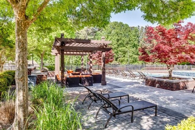 4175 Howell Park Road Duluth, GA 30096 - Photo 30 of 36 a view of a patio with table and chairs potted plants and large tree