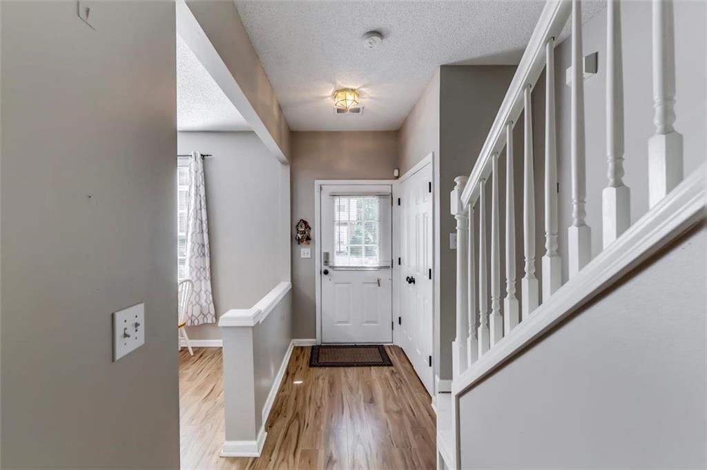 4175 Howell Park Road Duluth, GA 30096 - Photo 3 of 36 a view of a hallway with wooden floor and staircase