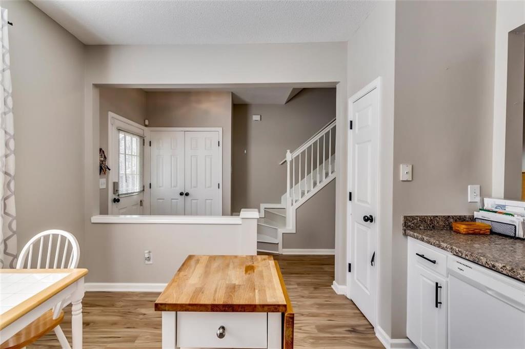 4175 Howell Park Road Duluth, GA 30096 - Photo 6 of 36 a view of kitchen island with furniture and wooden floor