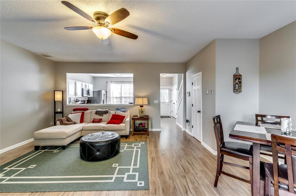 4175 Howell Park Road Duluth, GA 30096 - Photo 9 of 36 a living room with furniture a ceiling fan and a rug