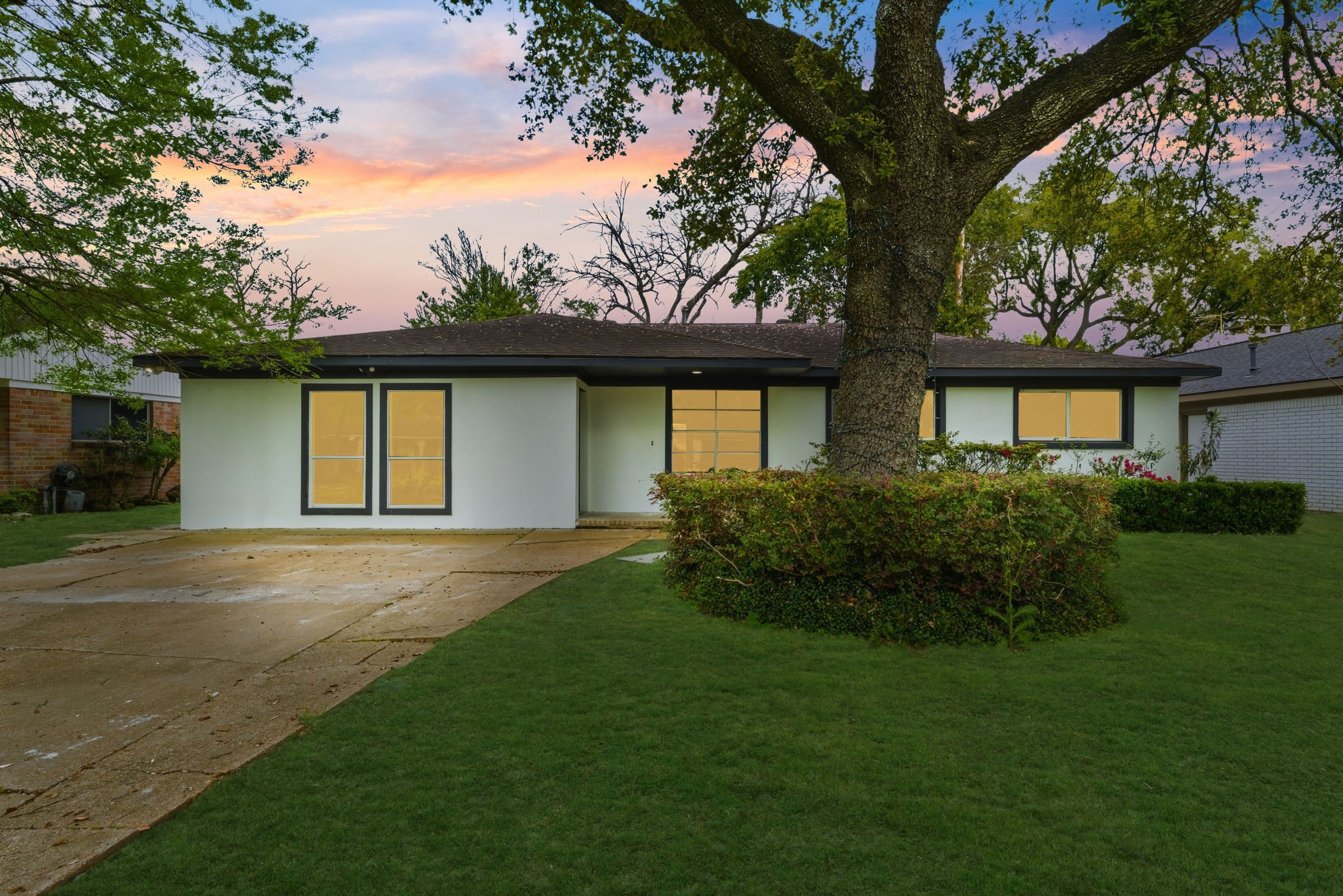910 Beaver Bend Road Houston, TX 77088 - Photo 2 of 48 A beautifully renovated home with striking modern curb appeal, mature shade trees, and a lush front lawn, where contemporary updates meet timeless neighborhood charm.