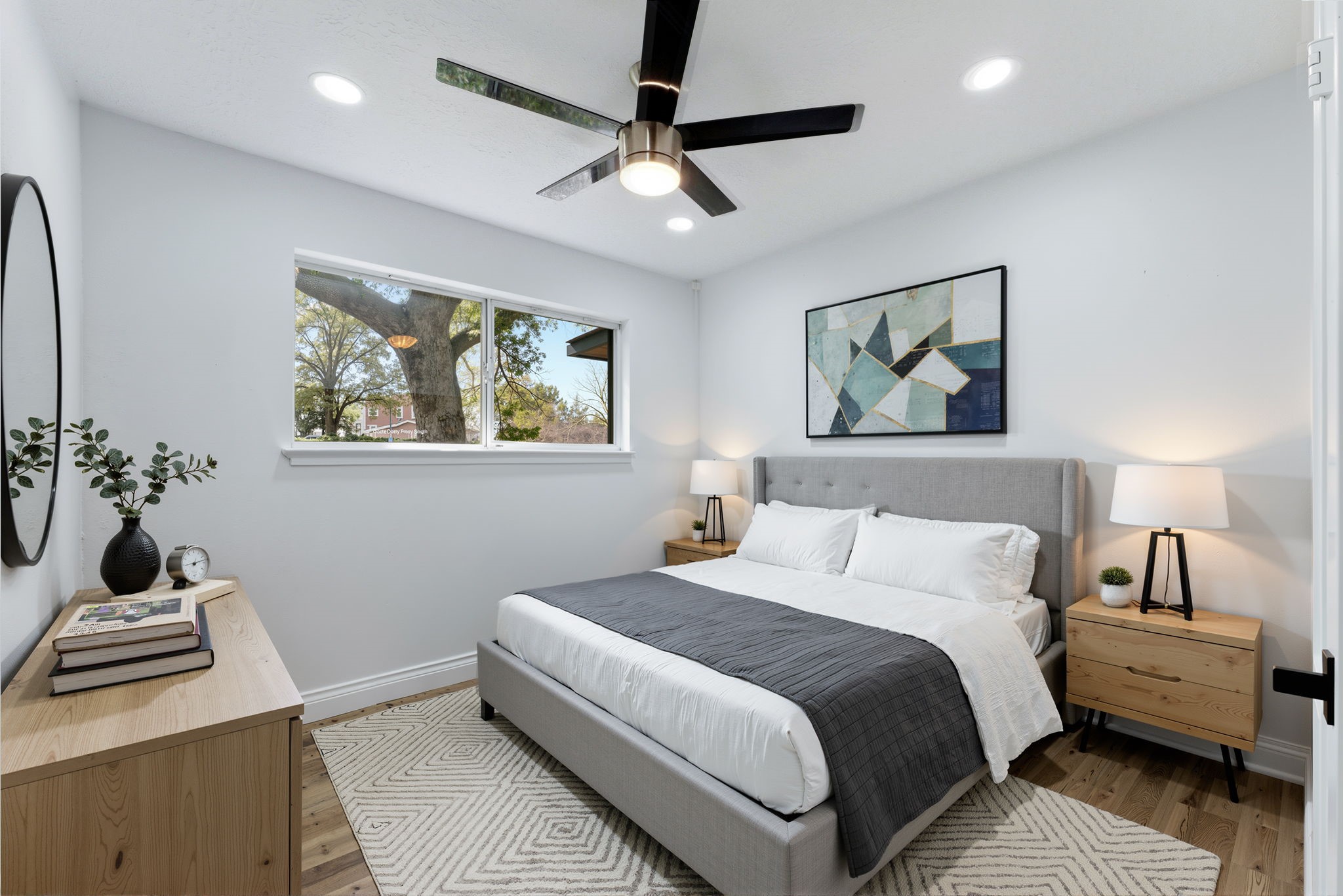 910 Beaver Bend Road Houston, TX 77088 - Photo 24 of 48 a bedroom with a bed wooden floor and window