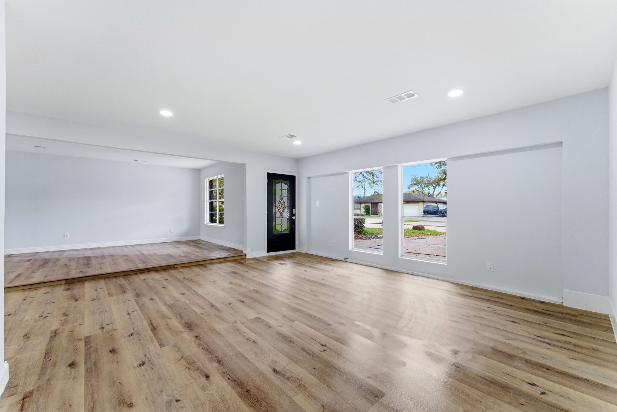 910 Beaver Bend Road Houston, TX 77088 - Photo 35 of 48 a view of an empty room with wooden floor and a window