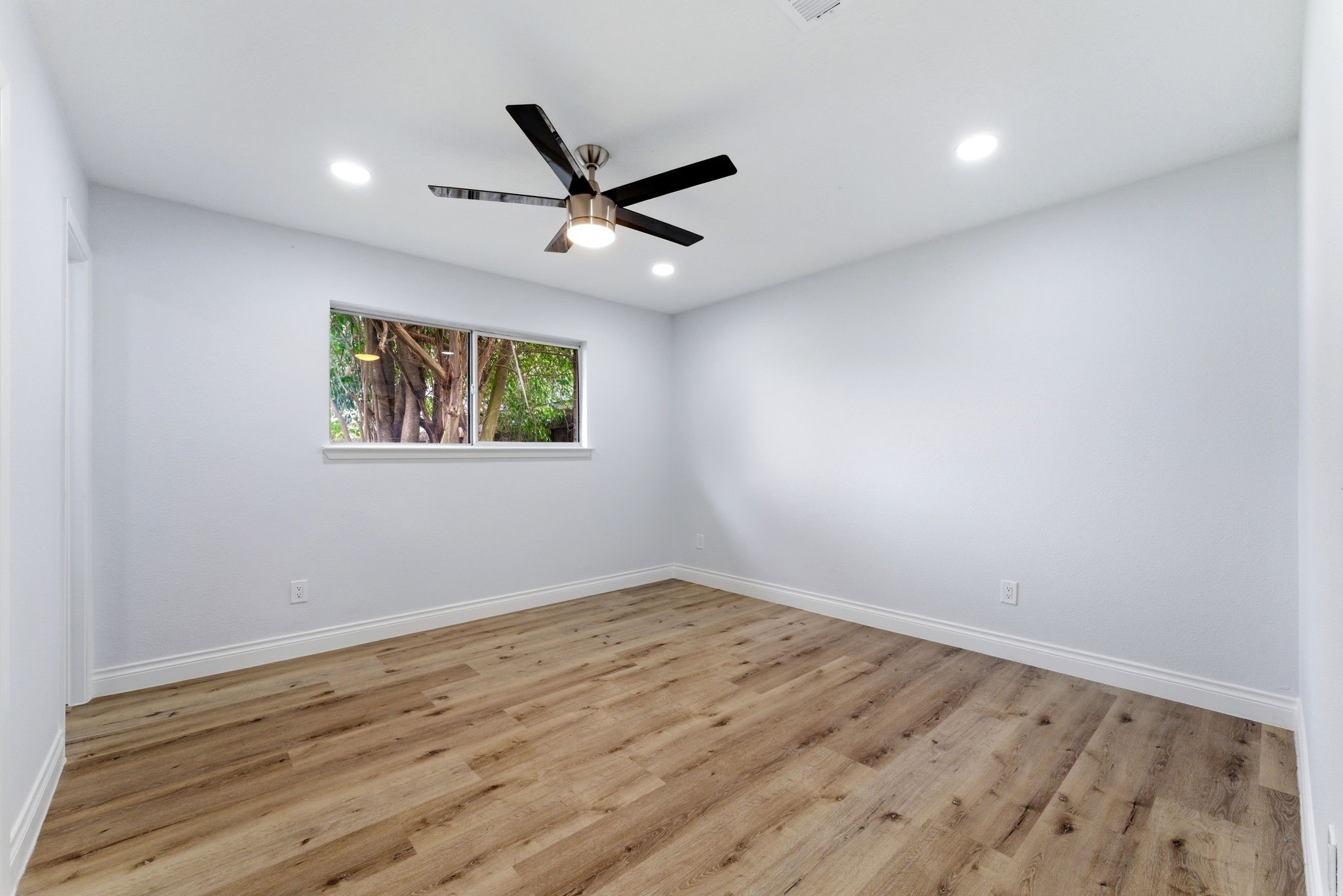 910 Beaver Bend Road Houston, TX 77088 - Photo 42 of 48 a view of empty room with wooden floor and fan