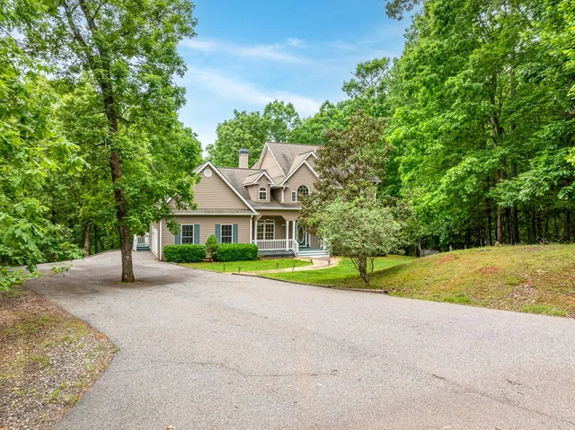 a house with a yard and a large parking space