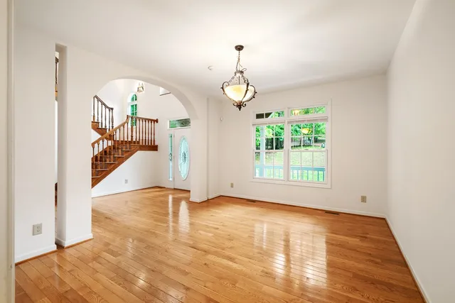 a kitchen with refrigerator a sink and wooden floor