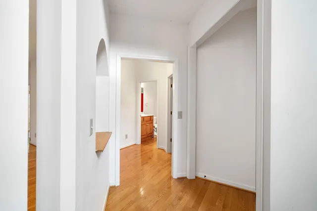 a kitchen with kitchen island a large counter top space appliances and a window