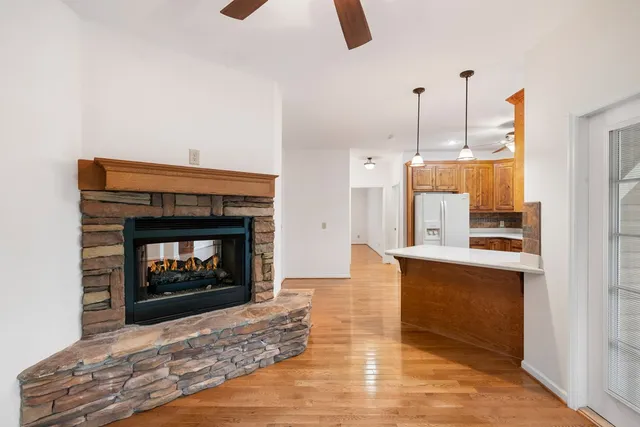 an empty room with a ceiling fan and a window