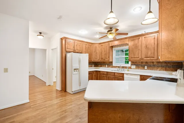 a view of a room with a ceiling fan and a window