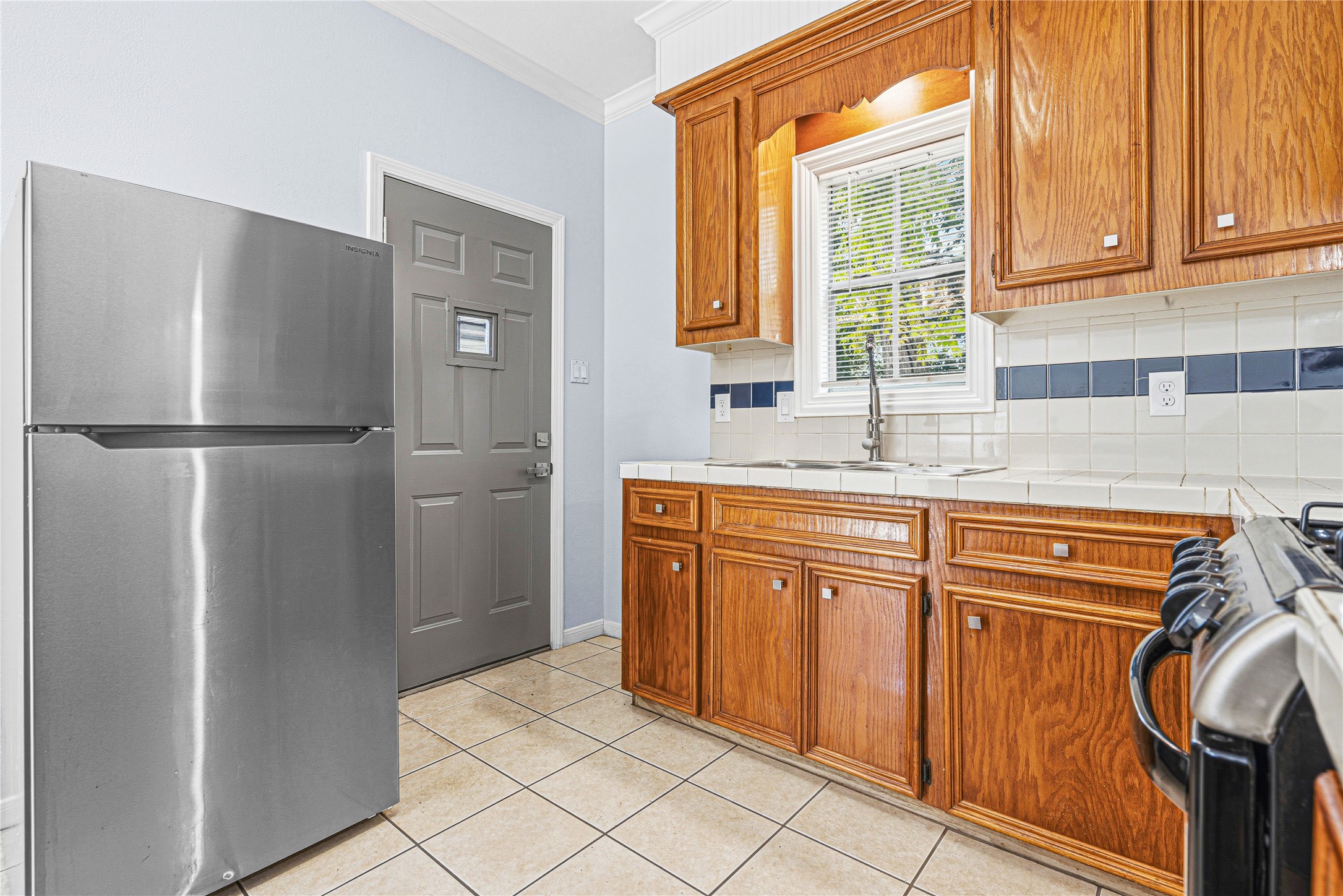 7839 Goode Street, Unit B Houston, TX 77012 - Photo 3 of 11 a kitchen with stainless steel appliances granite countertop a refrigerator and a sink