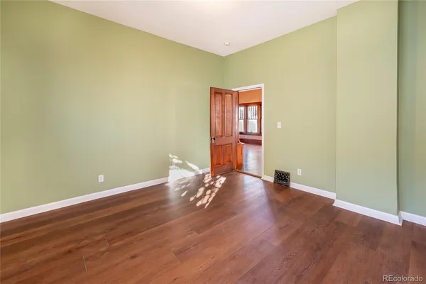 a view of a room with wooden floor